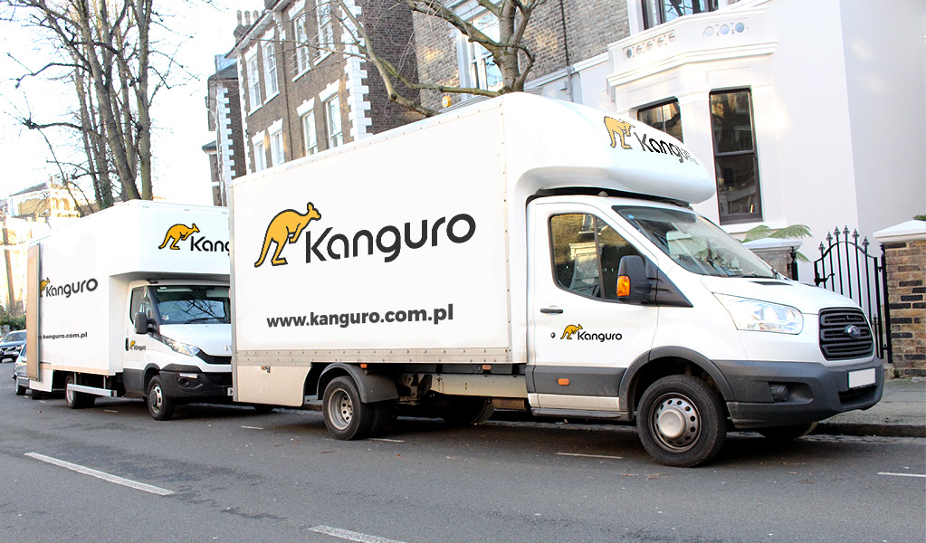 Two Kanguro removal trucks parked on a residential street – shared-load removals to Europe