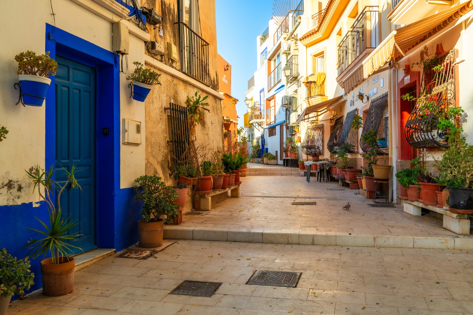 Stepped street with colourful doorways and flower pots in Alicante – removals from the UK to Alicante
