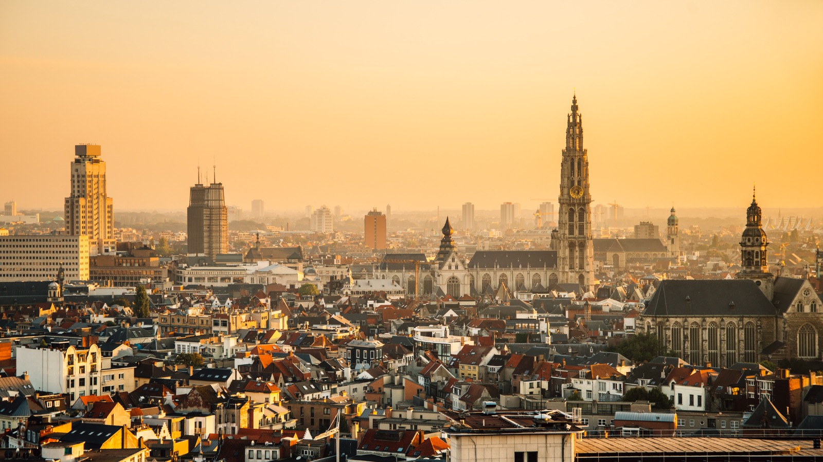 Antwerp skyline with cathedral towers at sunset – moving from the UK to Antwerp