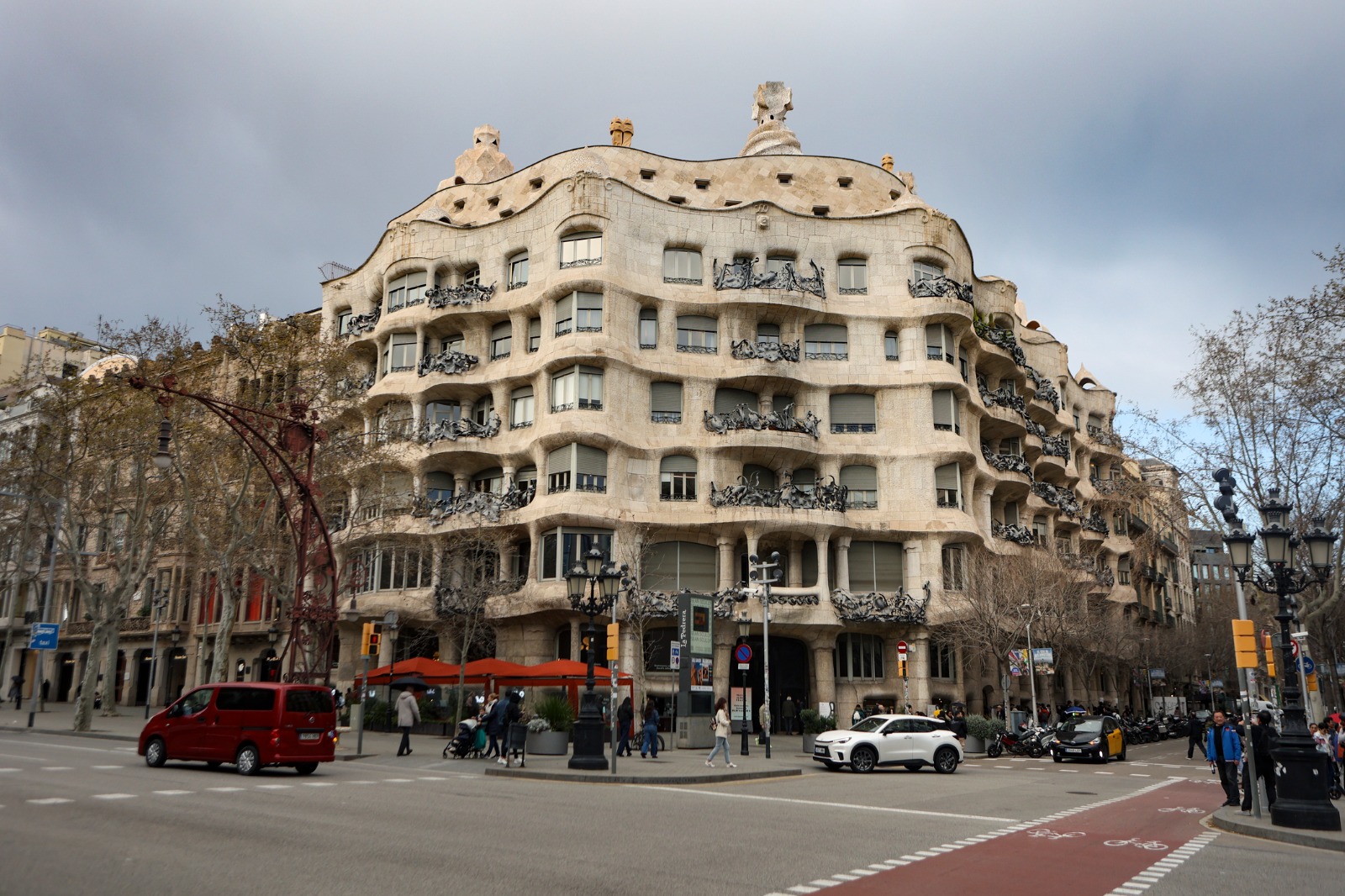 Casa Mila and traffic on a street in Barcelona – removals from the UK to Barcelona