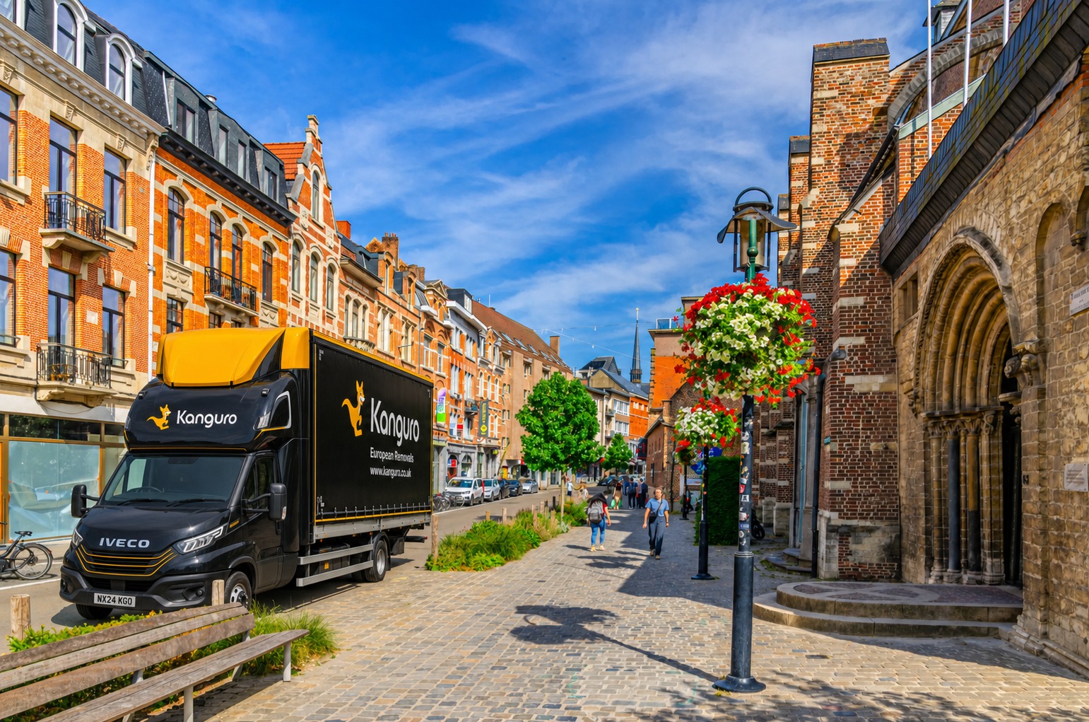 Kanguro removal truck beside historic brick buildings in Belgium – removals from the UK to Belgium