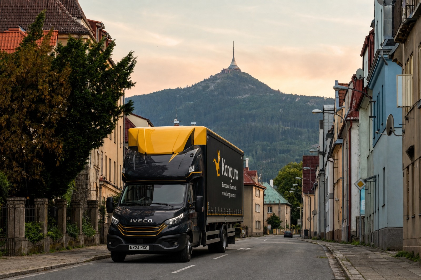 Kanguro removal truck on a residential street beneath a mountain in the Czech Republic – man and van removals from the UK to the Czech Republic