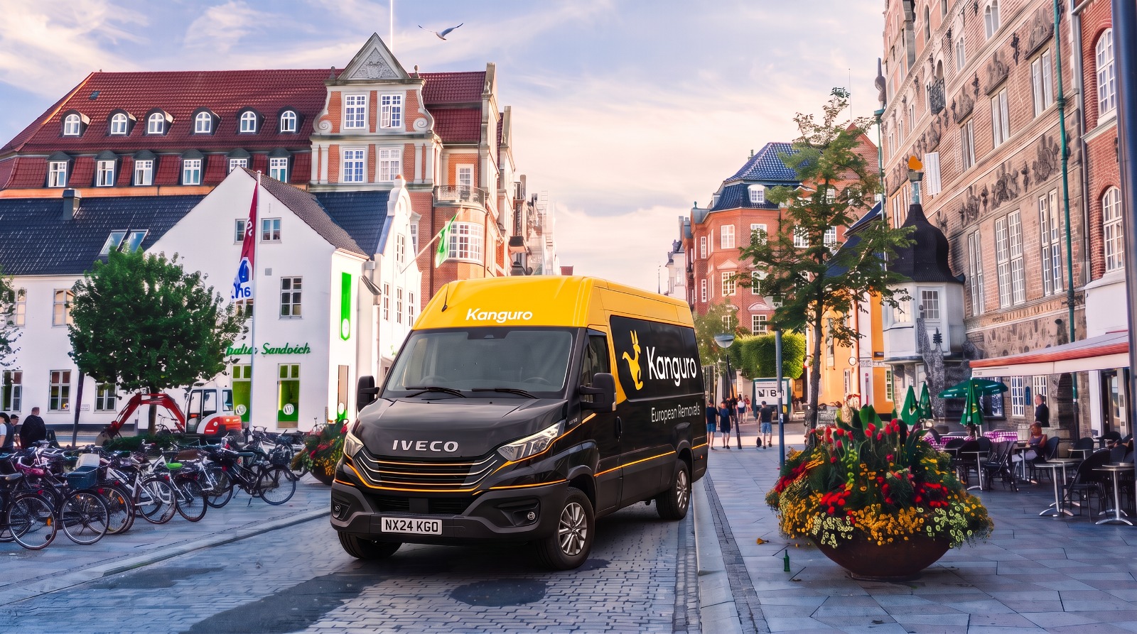 Kanguro removal van on a street with bicycles and flowers in Denmark – shared-load removals from the UK to Denmark