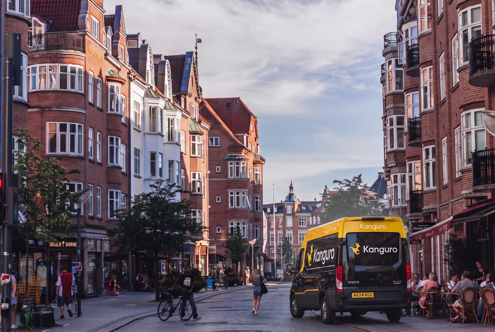 Kanguro removal van between brick apartment buildings in Denmark – dedicated removals from the UK to Denmark