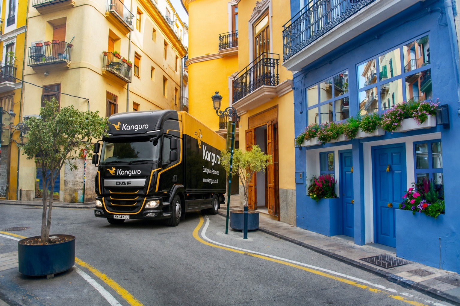 Kanguro removal truck beside colourful street-front buildings in Spain – man and van removals from the UK to Spain