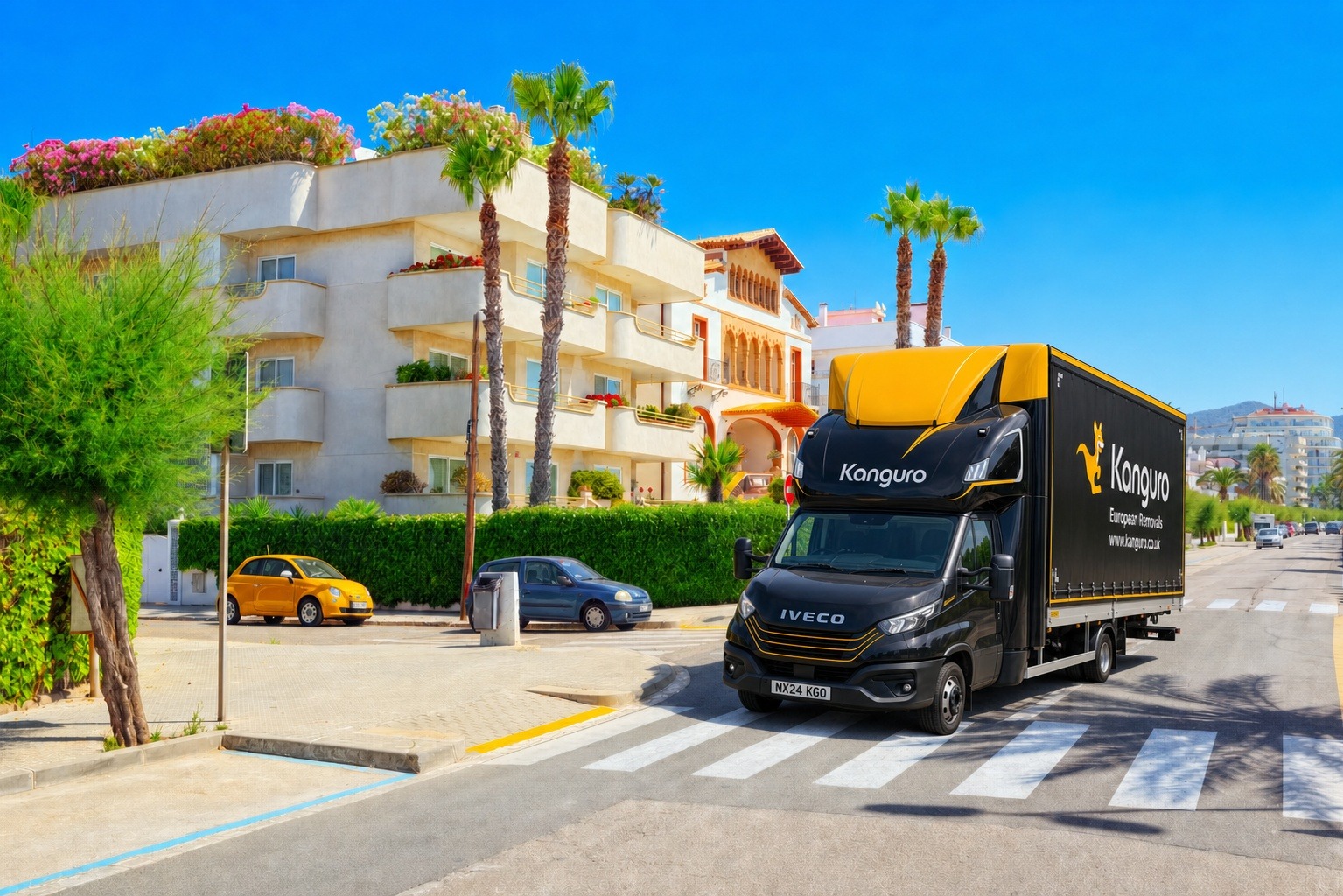Kanguro removal van beside palm trees and apartments in Spain – shared-load removals from the UK to Spain