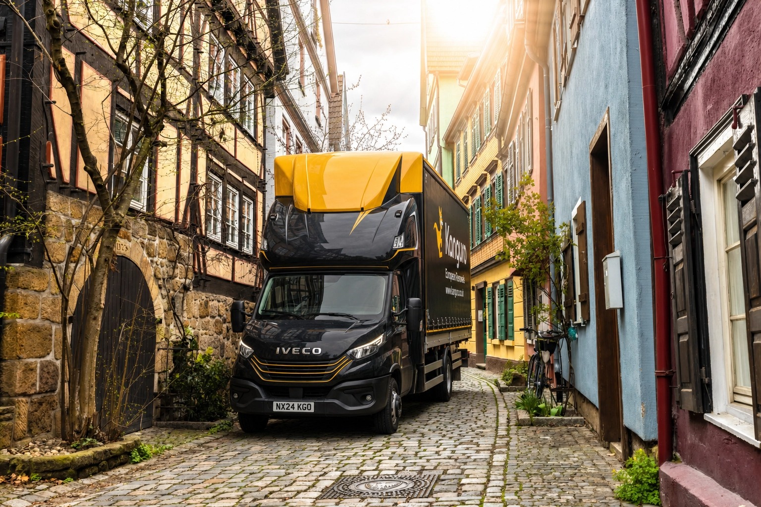 Kanguro removal truck on a narrow cobbled street with timber-framed buildings – removals from the UK to Germany