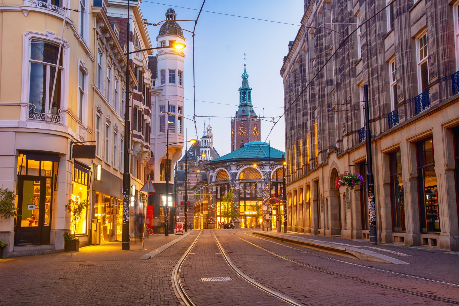 Tram tracks between historic buildings in The Hague at dusk – part-load removals to The Hague