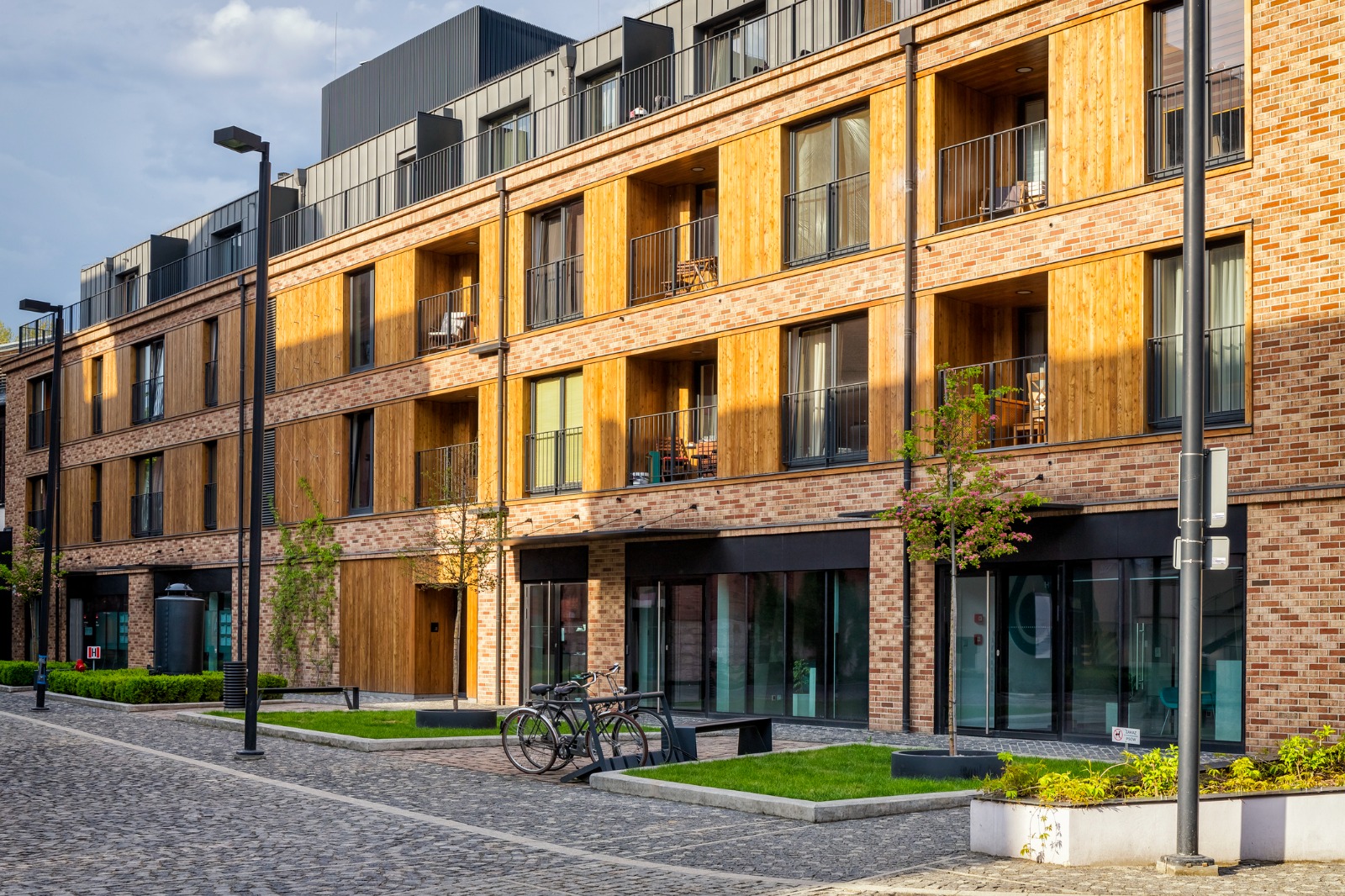 Modern brick apartment buildings beside a residential street in Poland – removals from the UK to Poland
