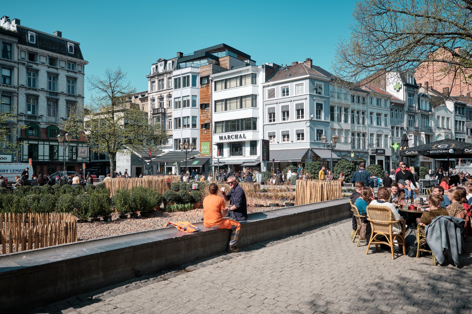 People at outdoor cafes in a square in Liege – removals from the UK to Liège