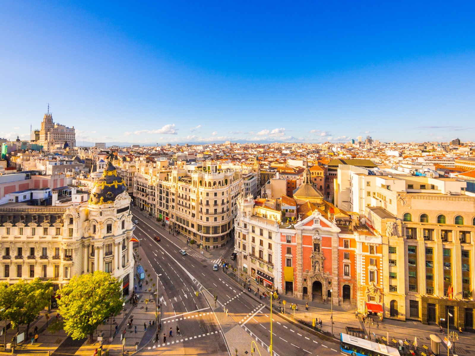 Madrid rooftops and a broad avenue under a blue sky – moving from the UK to Madrid