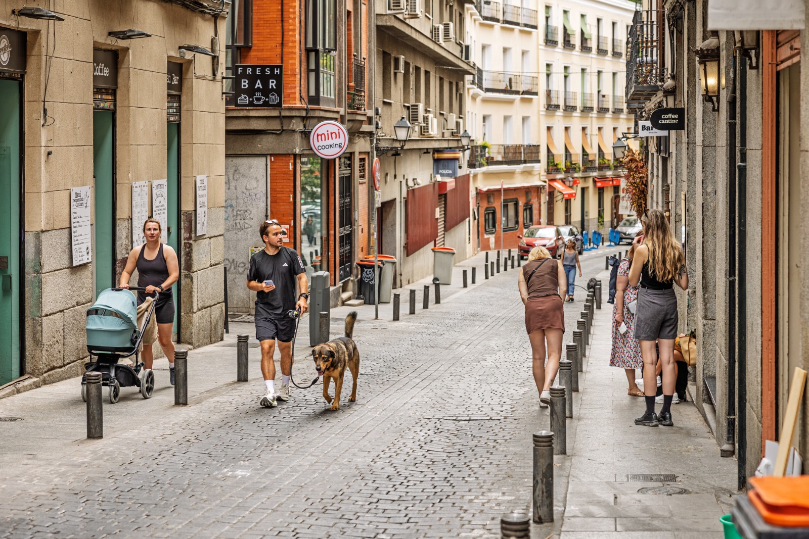 Pedestrians on a narrow cobbled street in Madrid – part-load removals to Madrid