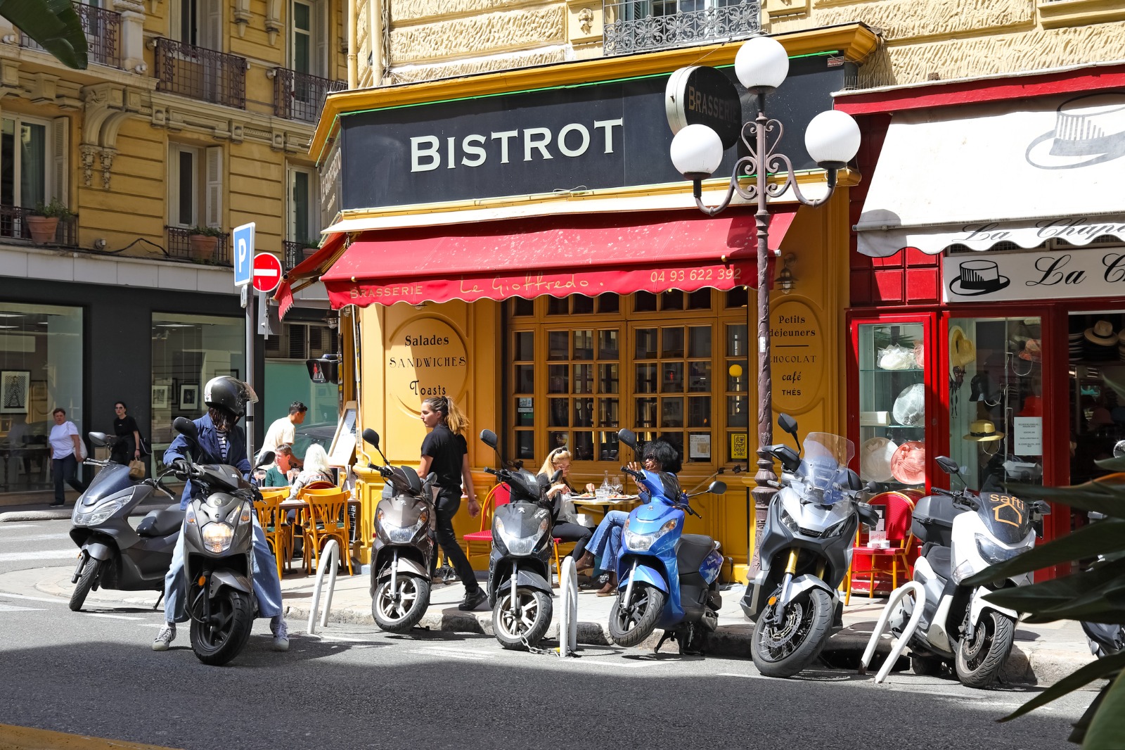 Parked scooters outside a bistro in Nice – moving from the UK to Nice