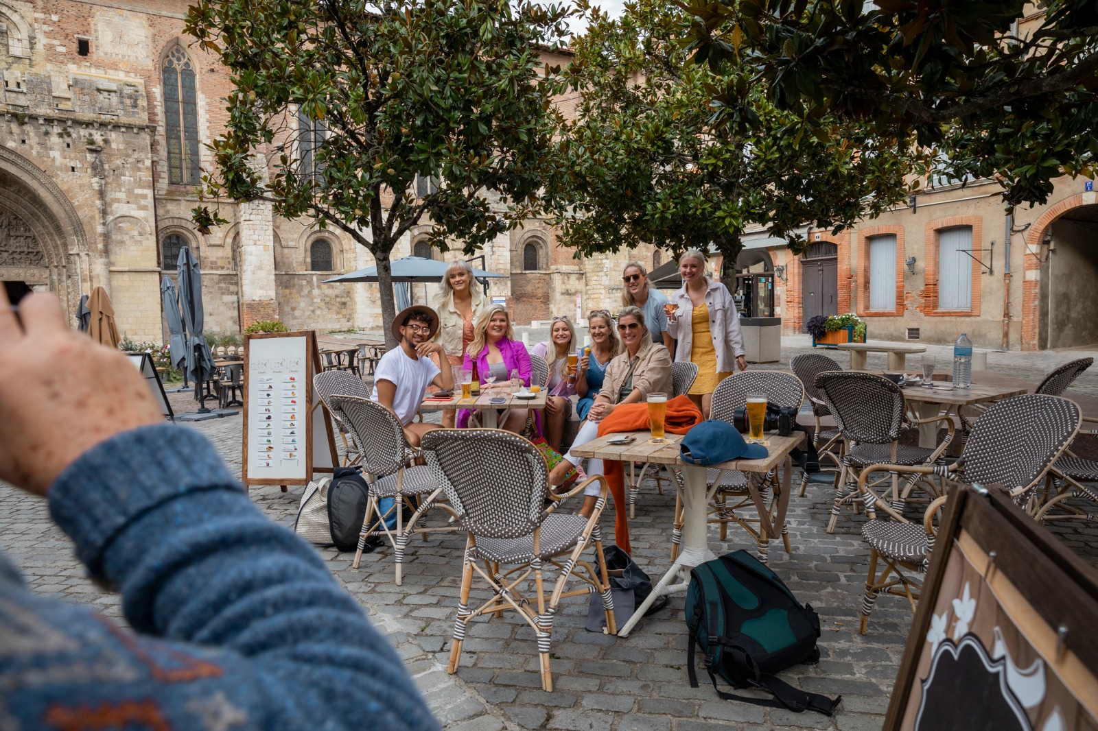Outdoor cafe beneath trees in a historic square in Toulouse – part-load removals to Toulouse