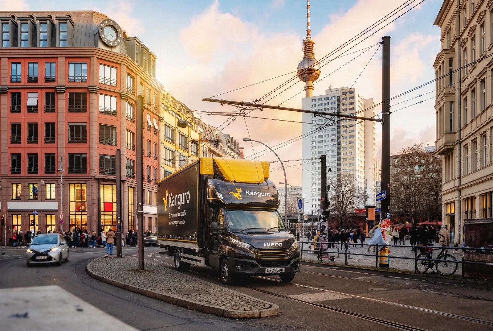 Kanguro removal van on a Berlin street with the television tower behind – removals from the UK to Berlin
