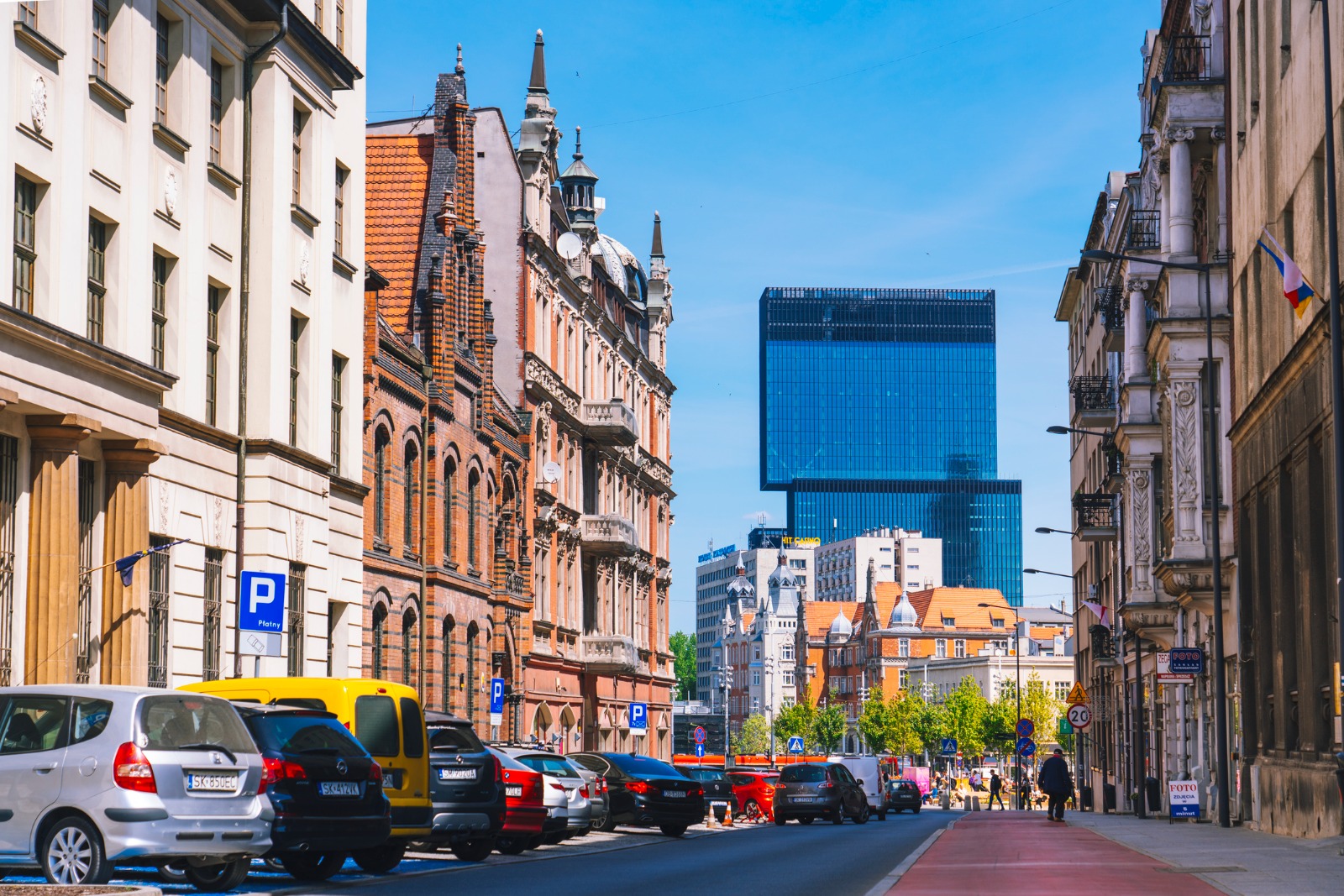 Street in Katowice with modern blue towers beyond historic buildings – shared-load removals to Katowice
