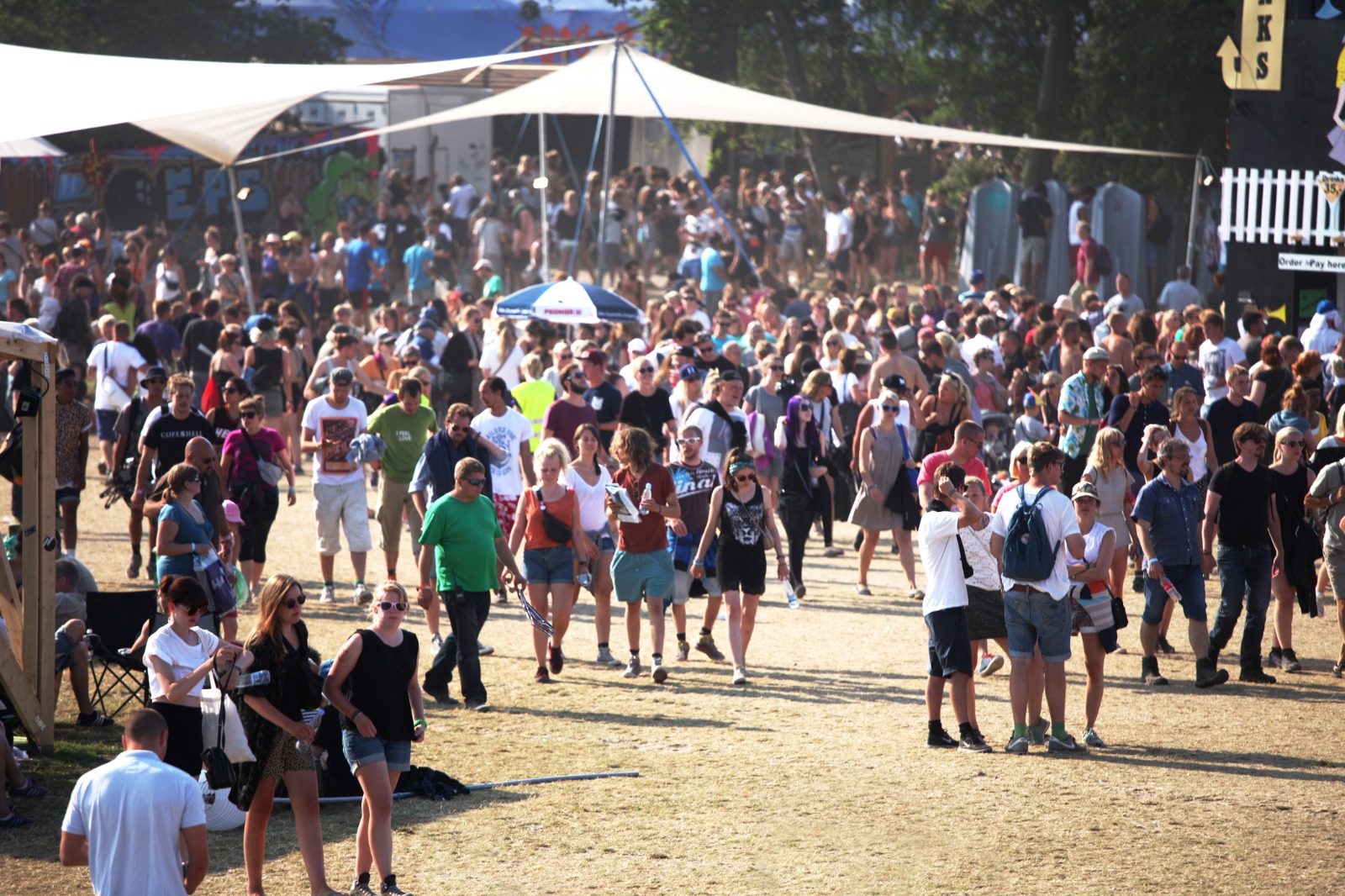 Crowd of visitors at an outdoor event in Roskilde – moving from the UK to Roskilde