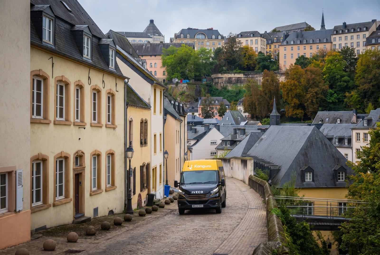 Kanguro removal van on a cobbled street beneath hillside buildings in Luxembourg – dedicated removals from the UK to Luxembourg
