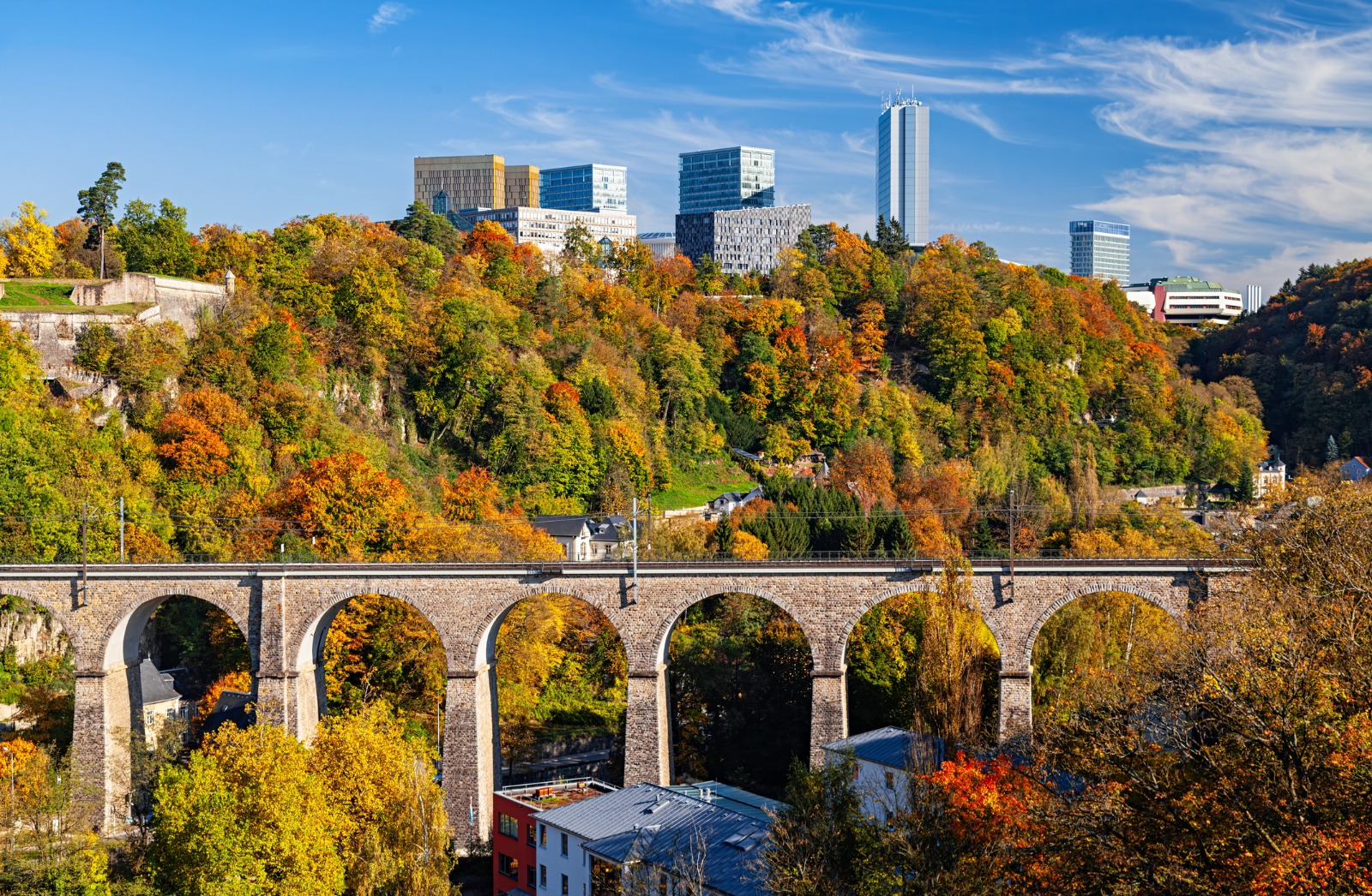 Stone viaduct and autumn trees in Luxembourg City – removals from the UK to Luxembourg