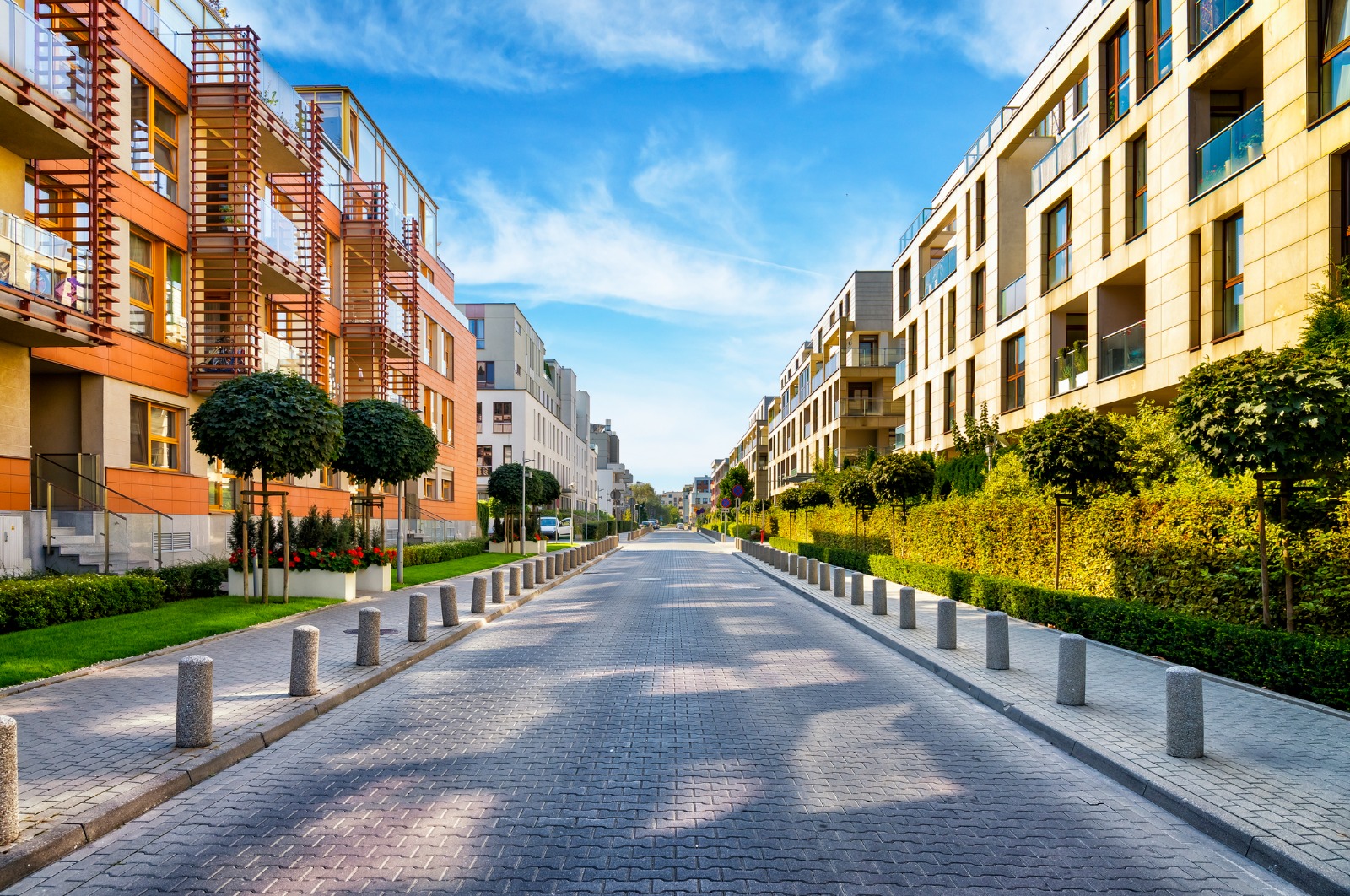 Modern apartment buildings beside a quiet residential street in Poland – shared-load removals from the UK to Poland