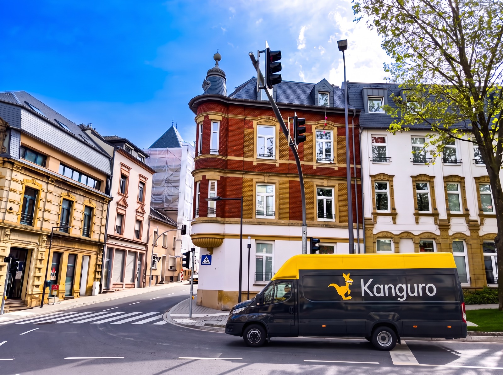 Kanguro removal van beside an ornate corner building in Luxembourg – part-load removals to Luxembourg